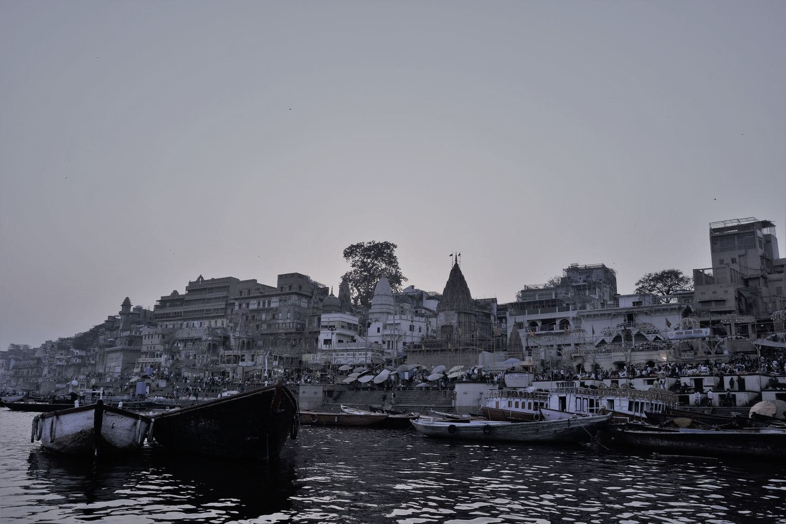 The ghats and temples of Varanasi seen from the river in black and white