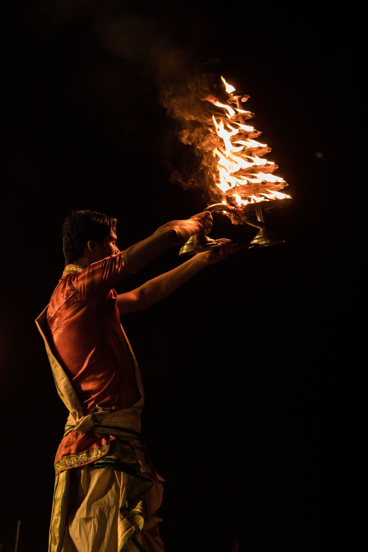 The tiered Aarti flame raised into the night