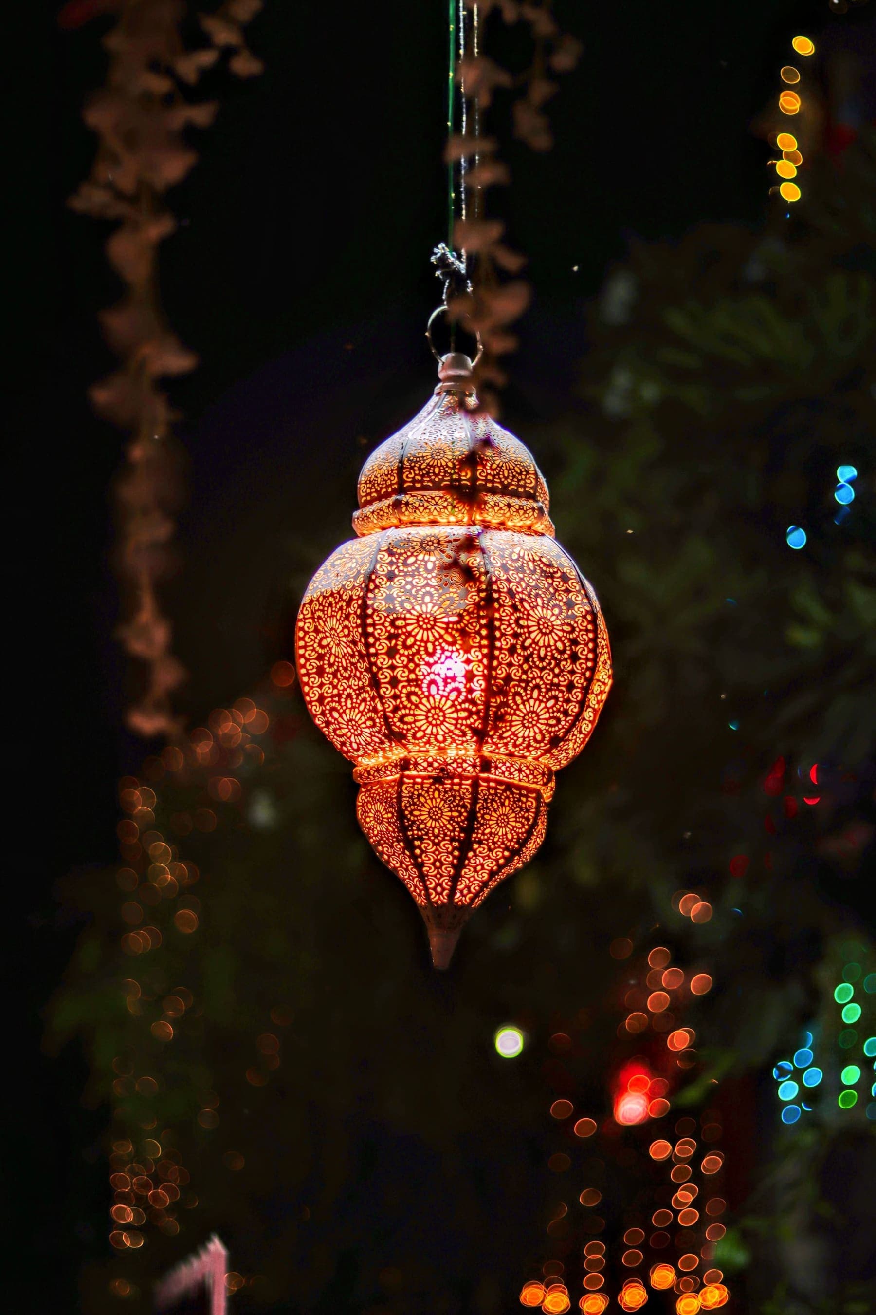 A pierced brass lantern glowing against the night